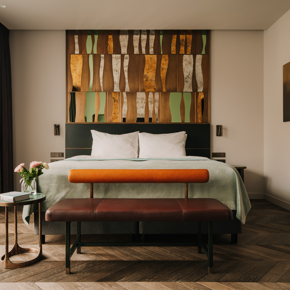 Łóżko King Size w hotelu The Cyrus pod miedzianą własnoręcznie robioną ozdobą w świetle słonecznym