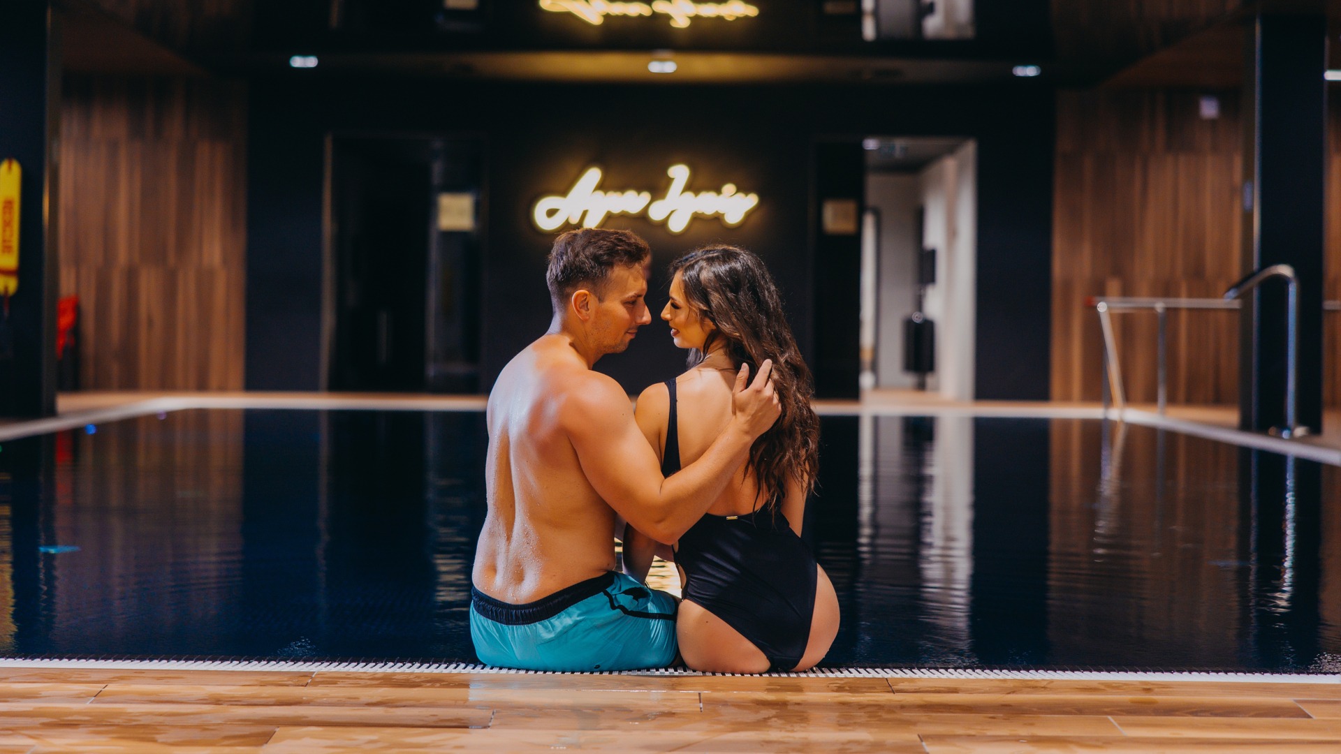 couple sitting by the pool