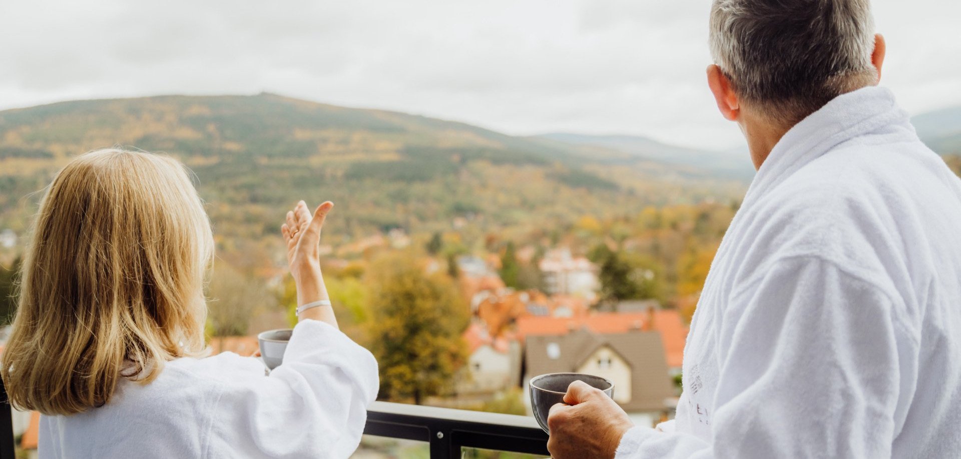 Couple on balcony with mountain view