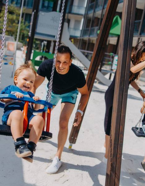 father and child on swing