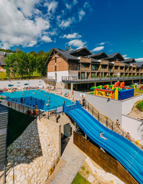 View of outdoor pool with water slide
