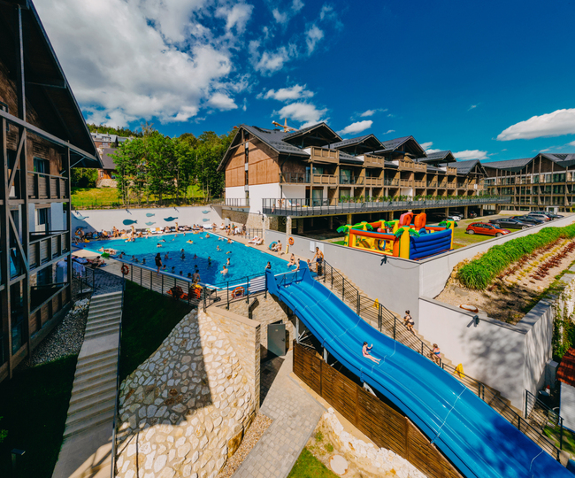 View of outdoor pool with water slide