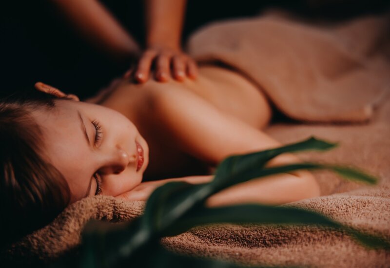 Child having massage at spa
