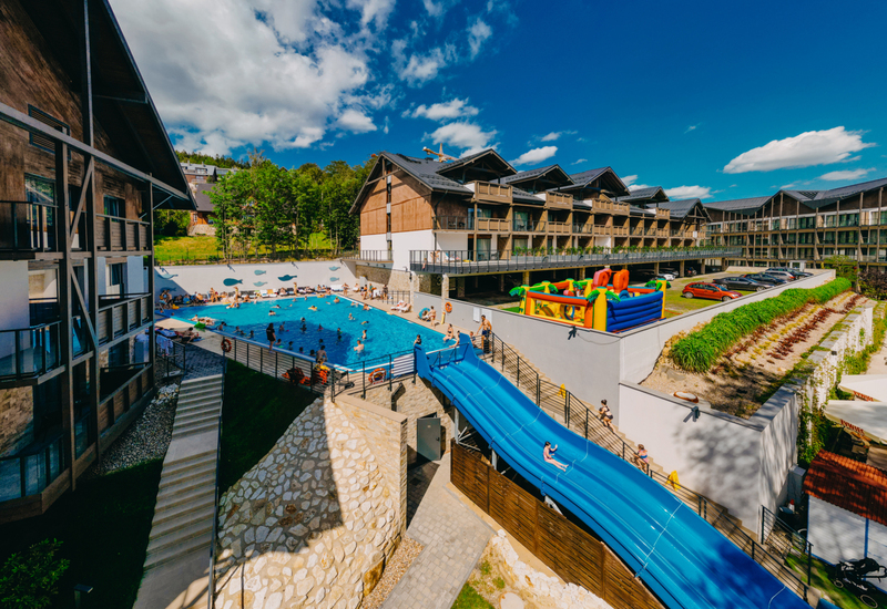 View of outdoor pool with water slide