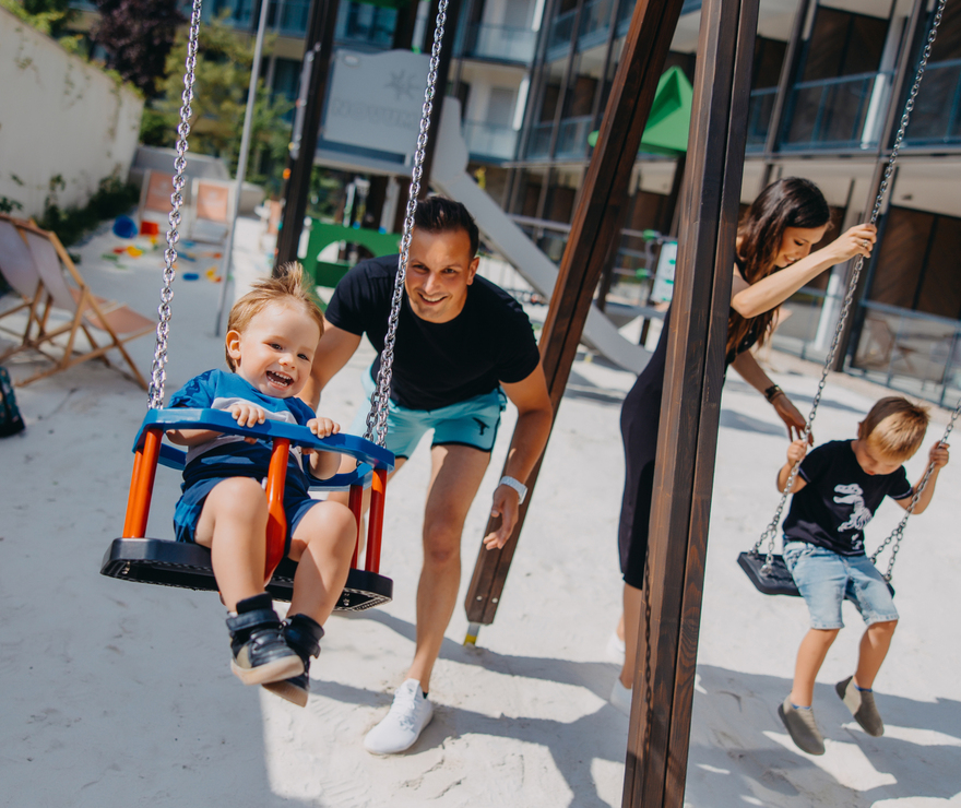 father and child on swing