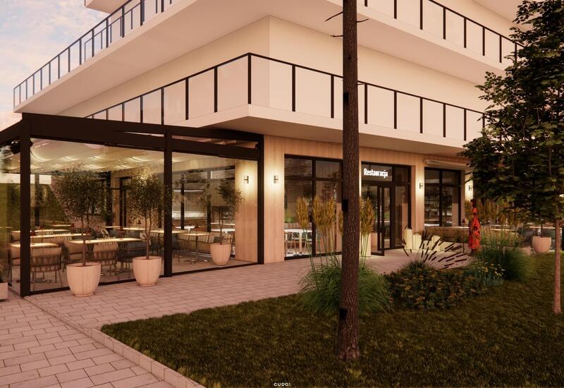 Szklana restauracja hotelowa z przytulnym oświetleniem, zadaszonym tarasem, donicami z drzewkami i zadbaną zielenią.