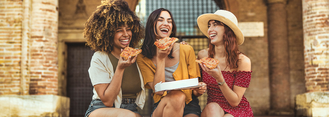 Friends sharing pizza and enjoying a relaxed weekend together