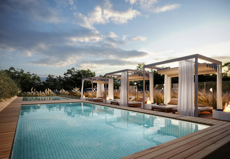 Sunset poolside with tiled pool, wooden deck, curtained cabanas, cushioned lounge beds and fire pits