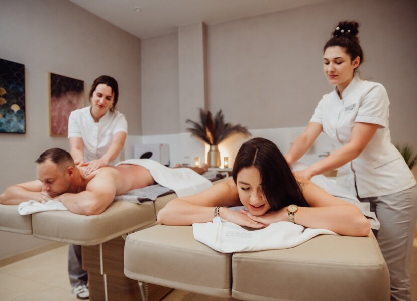 couple receiving massage from masseuses