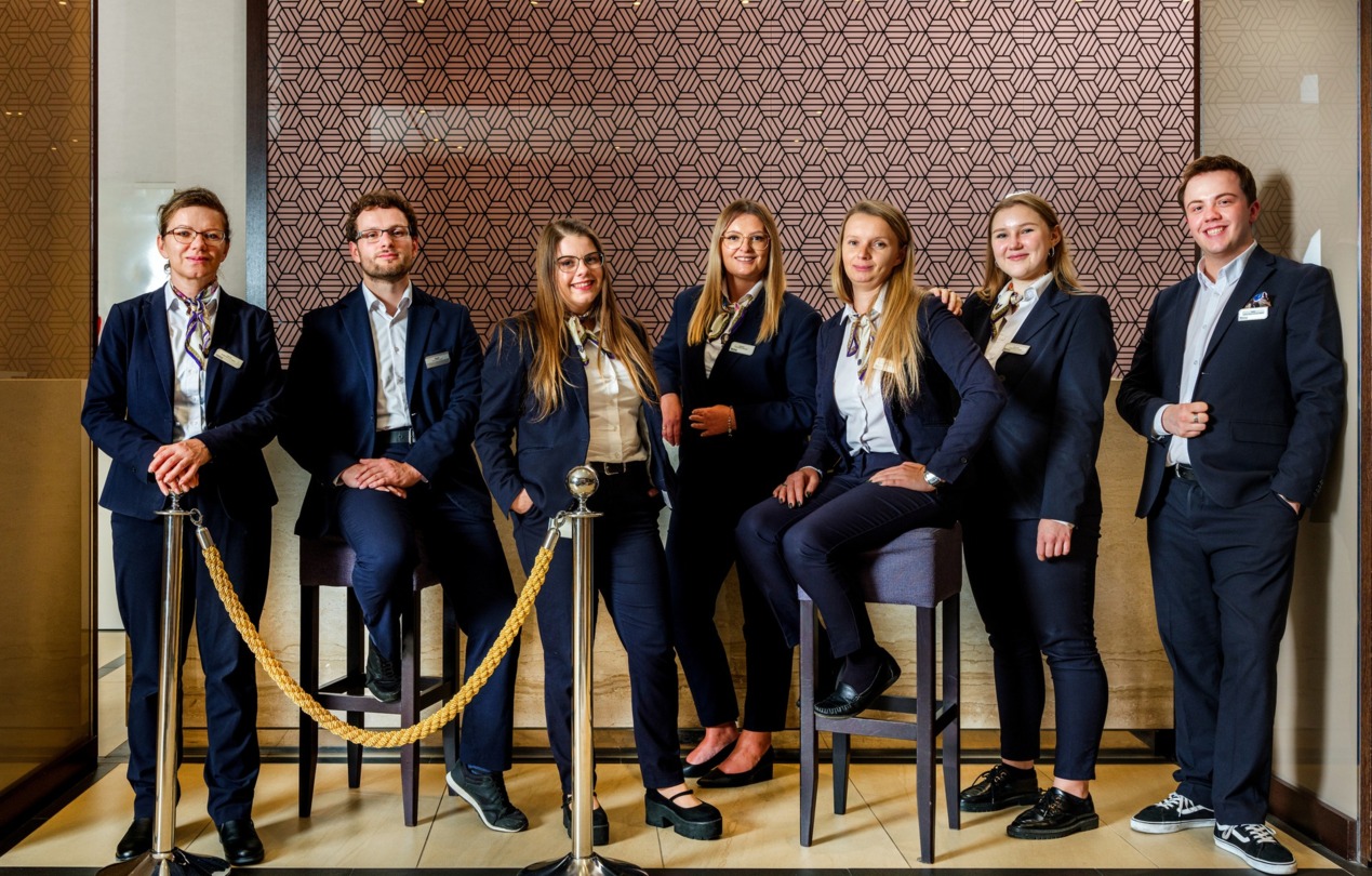 A group photo of the hotel reception staff.