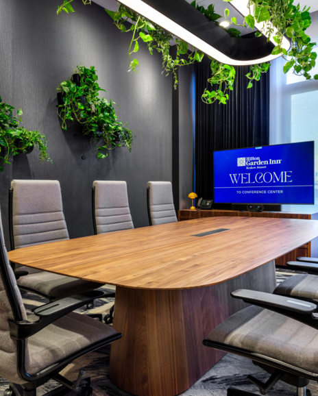 Zdjęcie sali konferencyjnej ze stołem prezydialnym i obrotowymi fotelami