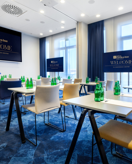 Interior of a training room with tables and chairs in a school setting.