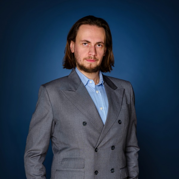 Portrait photo of a hotel general manager in a gray suit