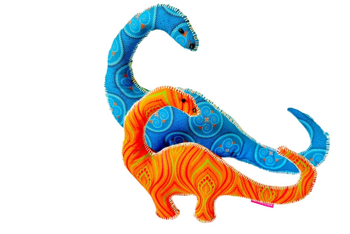 Two colorful fabric dinosaur toys with detailed stitching and vibrant patterns in blue and orange hues
