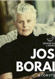Portrait of a person with short white hair sitting on a striped cushioned chair, wearing a black turtleneck sweater