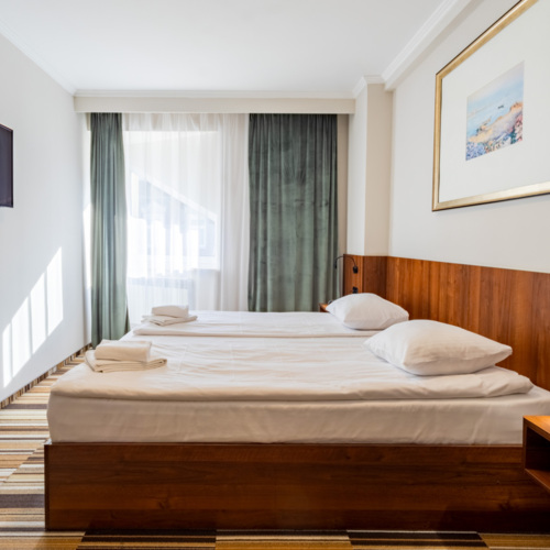 Wnętrze pokoju dwuosobowego z łóżkiem małżeńskim w Hit Hotelu Warszawa