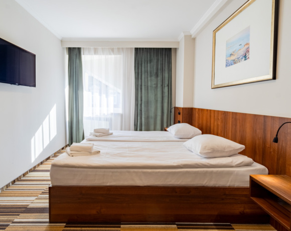 Wnętrze pokoju dwuosobowego z łóżkiem małżeńskim w Hit Hotelu Warszawa