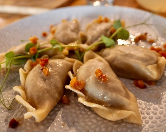 Pierogi with topping and fresh herbs served in the hotel restaurant