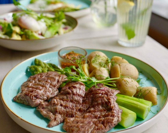 Grilled beef with potatoes and vegetables served in the hotel restaurant