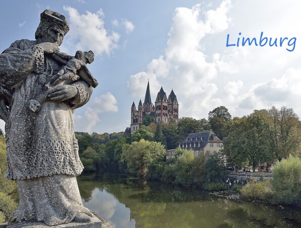 Historische Statue blickt auf Fluss mit grünen Bäumen und die markante Limburger Kathedrale auf einem Hügel unter leicht bewölktem Himmel