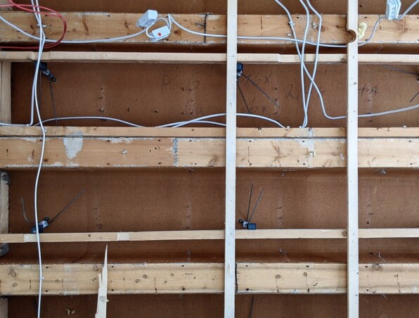 Exposed wooden framework with electrical wiring during hotel room renovation or construction phase