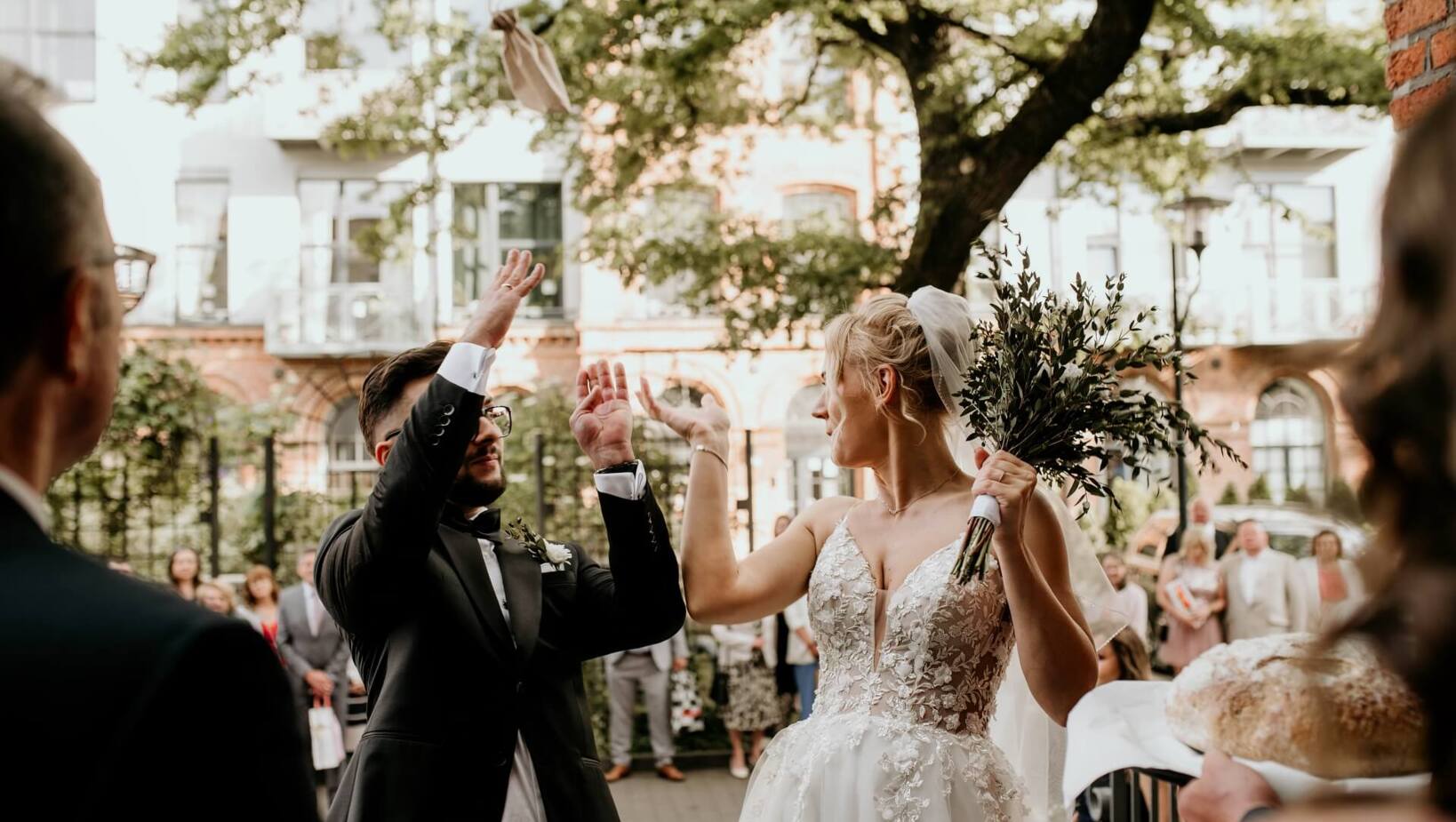 Bride and groom throwing glasses before entering the wedding hall in Tobaco Park Hotel Łódź
