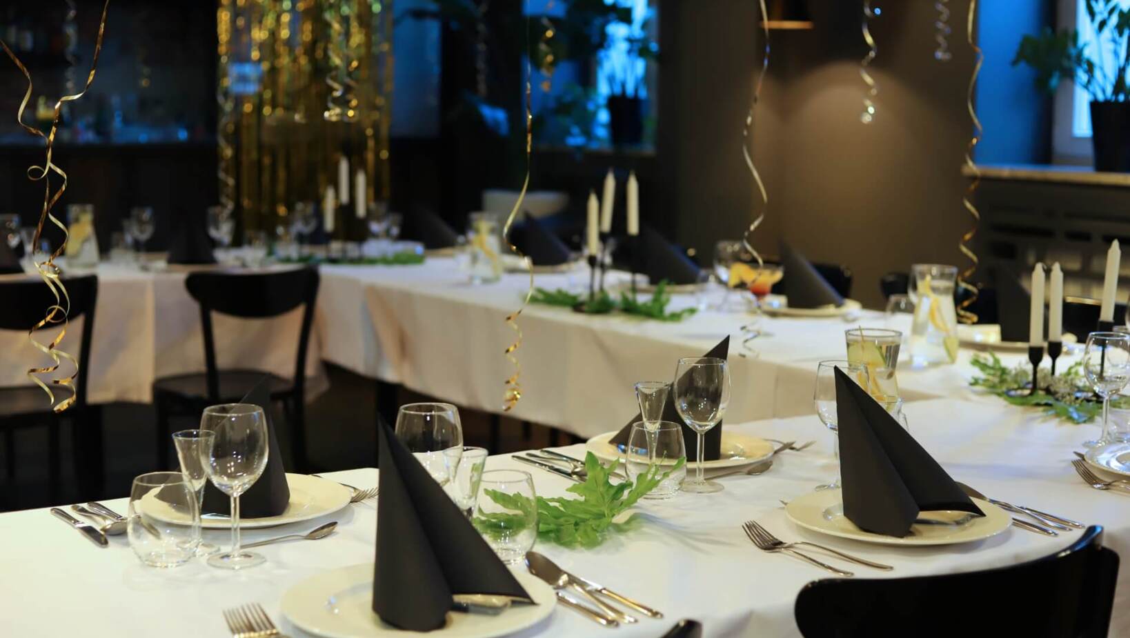 Elegant black and white table decorations with hanging birthday streamers