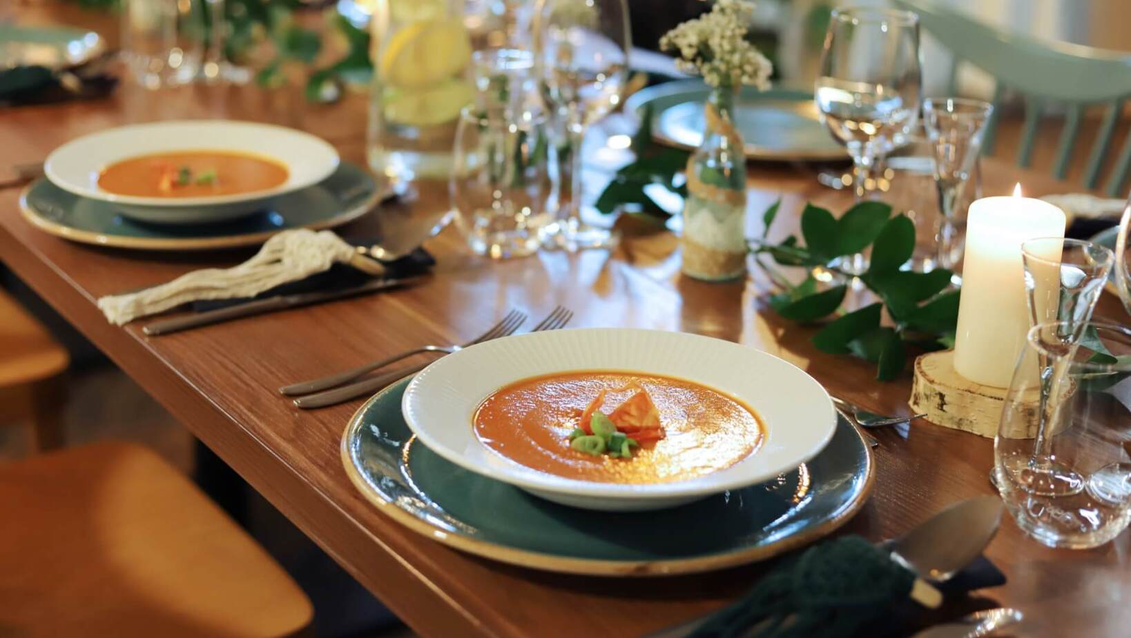 Soup as a first course served at a rustic set table in the restaurant