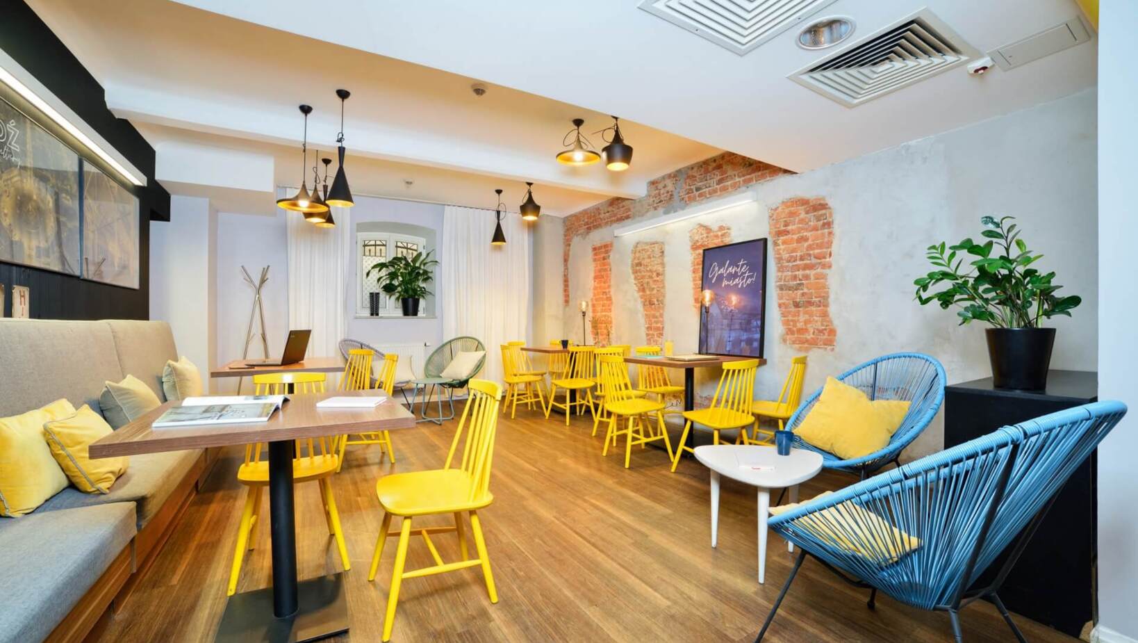Colorful restaurant room with comfortable armchairs and chairs