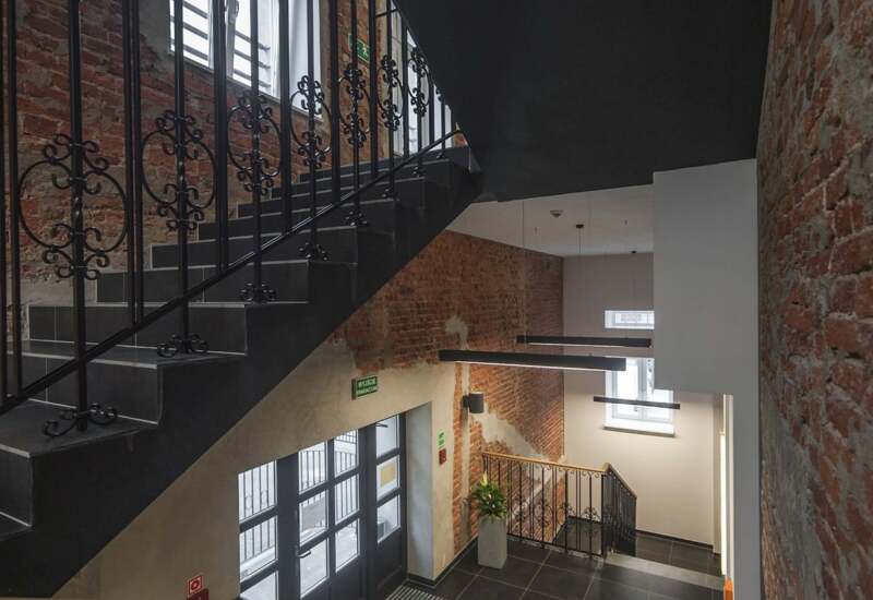 Hotel staircase in industrial style with brick wall