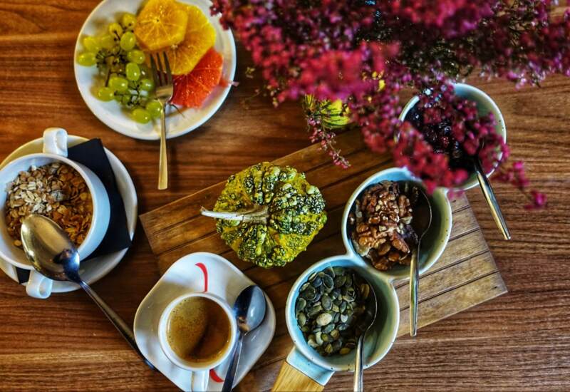 View of a table with flowers, tea, fruits and accompaniments