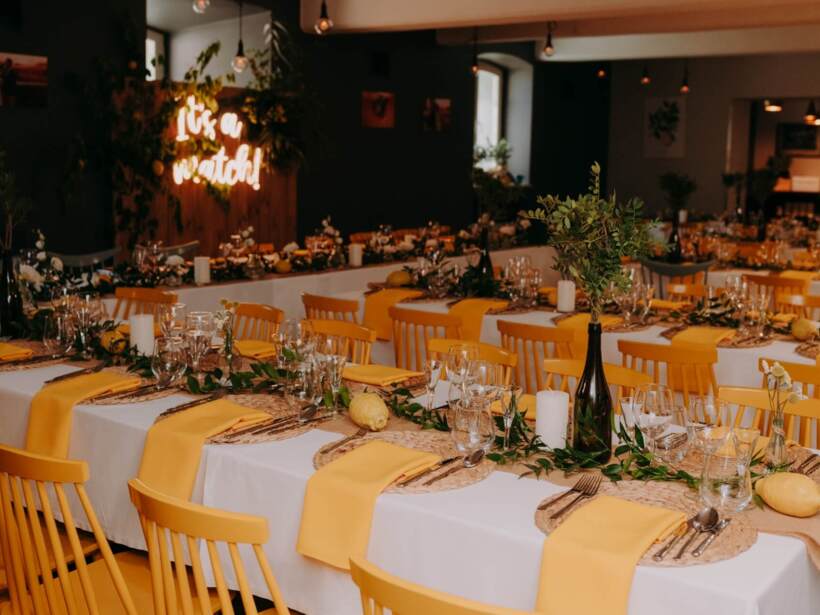 Wedding hall with colorful flowers and rustic styled table settings