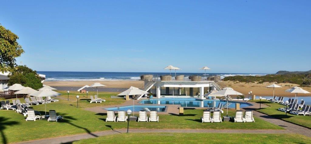 Outdoor swimming pool and lawns overlooking the beach at Mpekweni Beach Resort