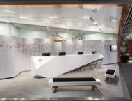 A modern hotel reception area with a bright colour scheme and minimalist design