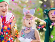 A group of children participating in a game led by an animator