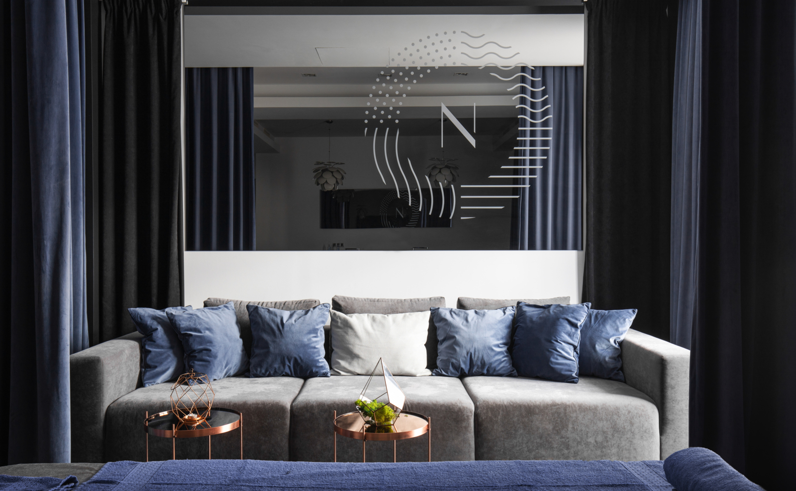 A comfortable relaxation area with a large sofa in a warm, elegant hotel interior