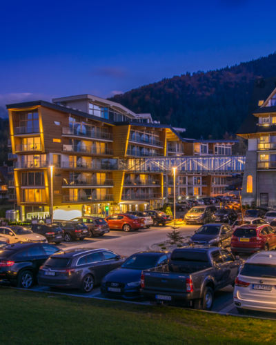 View from the car park of the Nosalowy Dwór resort illuminated in the evening