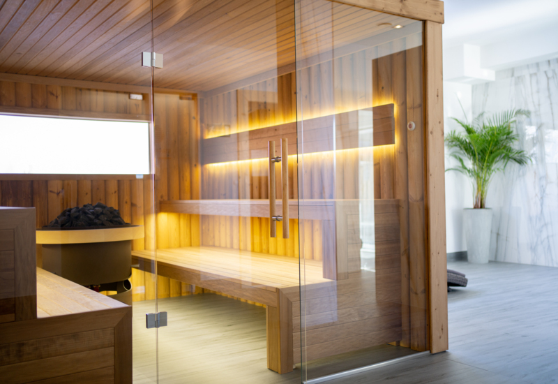 Moderná parná sauna s jemným osvetlením, ktoré vytvára relaxačnú atmosféru.