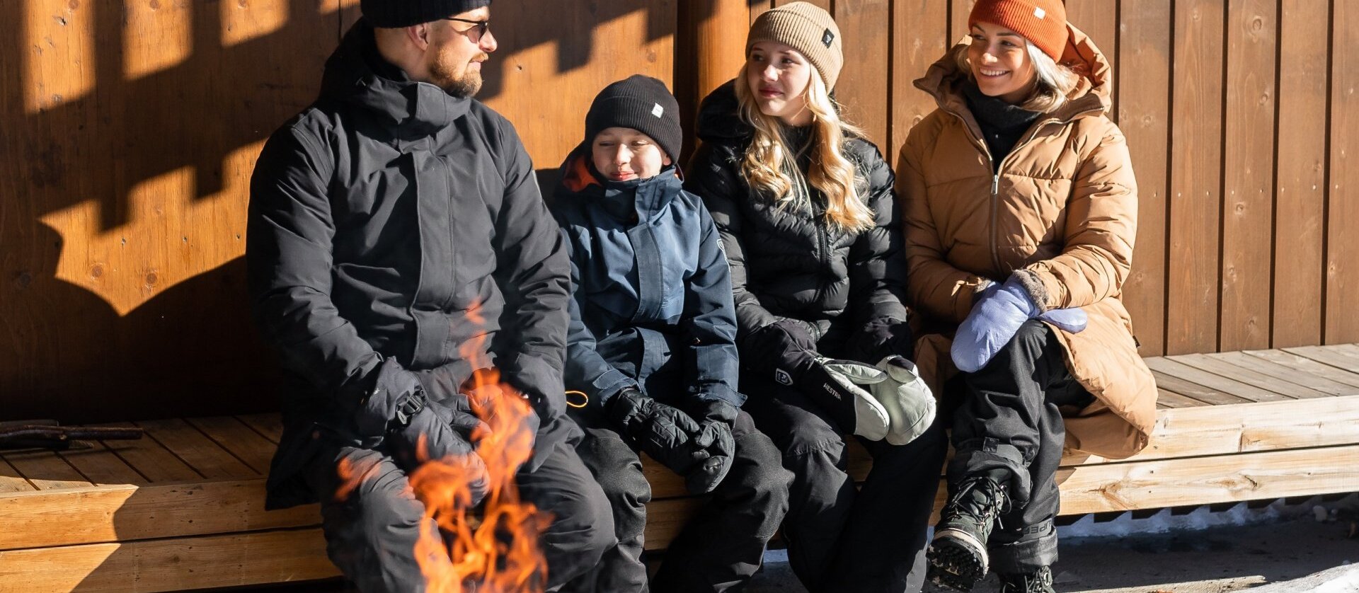 Family enjoying campfire outside at Nova Skyland Hotel