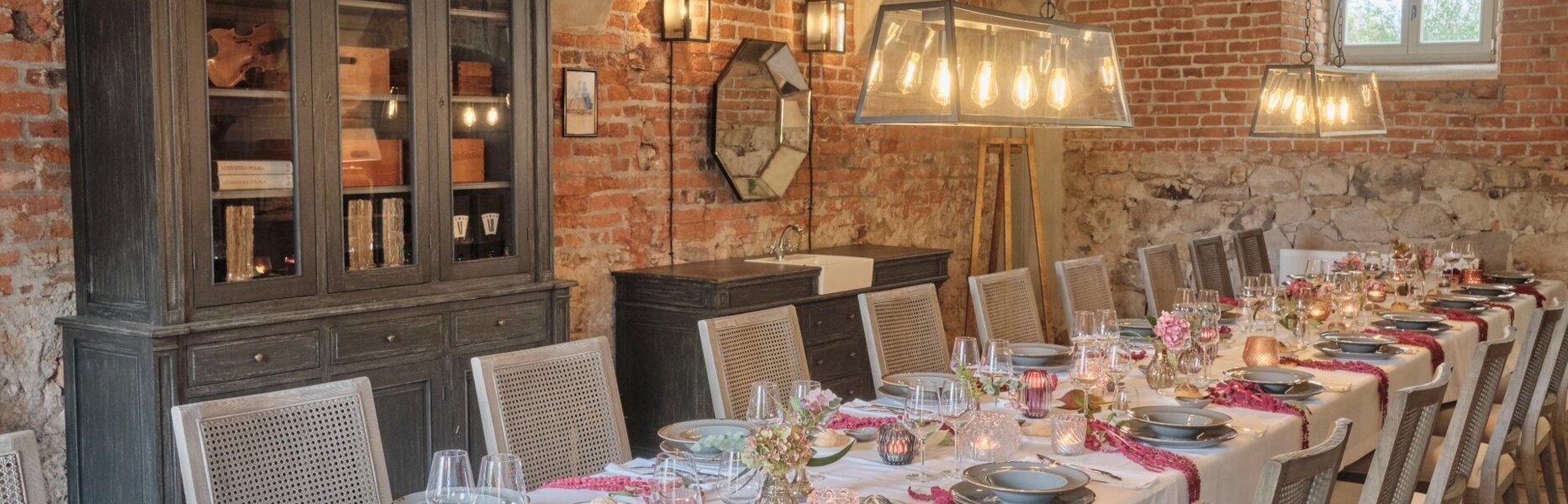 Udekorowany stół w sali w Folwarku w Pałacu Kamieniec. Gustowne dekoracje. Przyjęcie rodzinne.