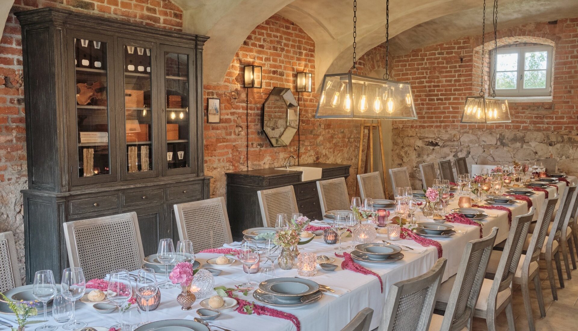 Udekorowany stół w sali w Folwarku w Pałacu Kamieniec. Gustowne dekoracje. Przyjęcie rodzinne.