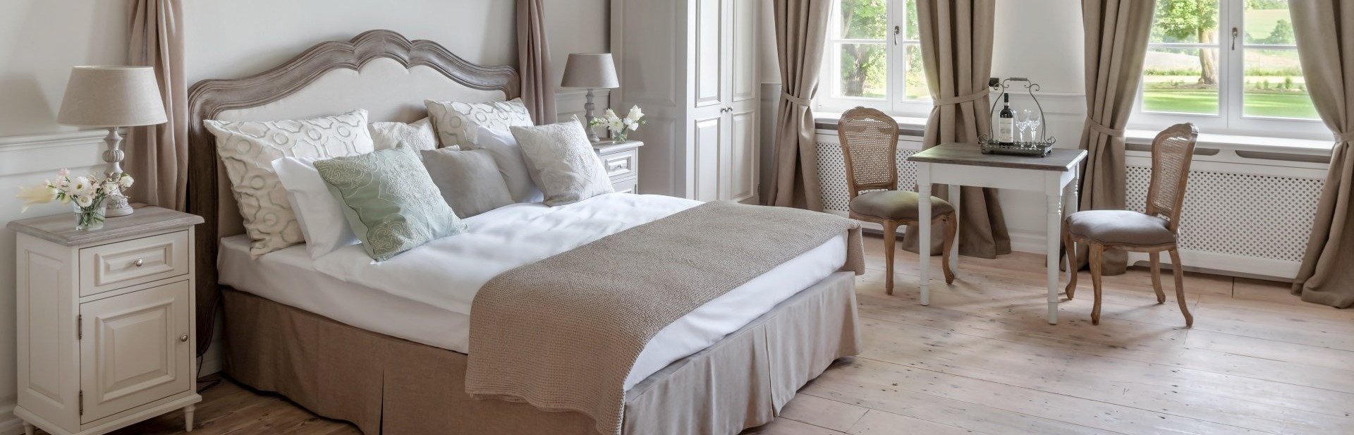 The romantic apartment in the Kamieniec Palace. The canopy bed. Wooden floor
