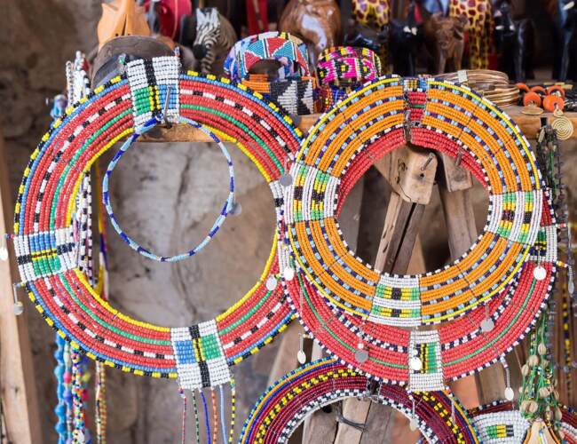 Colorful traditional beaded necklaces on display in a local artisan market, showcasing vibrant patterns and craftsmanship