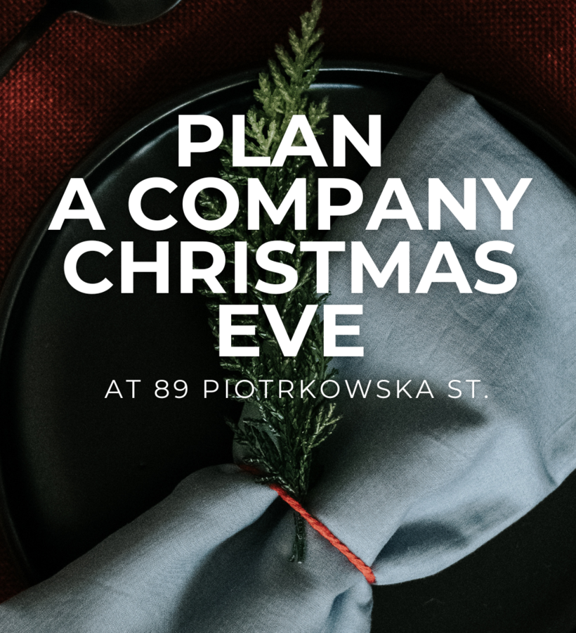 Napkin tied with a red ribbon and a green sprig on a black plate against red fabric, an invitation to the company Christmas Eve celebration