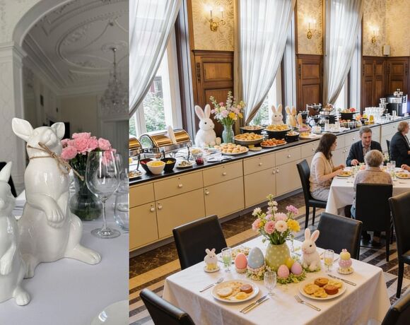 Elegantes Hotel-Frühstücksbuffet zu Ostern mit Gebäck, Keramik- und Plüschhasen, Blumenarrangements und Gästen beim Essen.