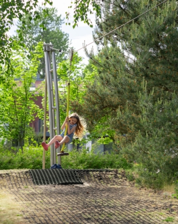 girl riding down the zip line