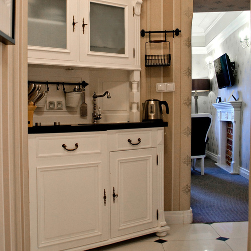 White kitchenette with a sink, cabinets and kettle in Junior Suite Deluxe Blue