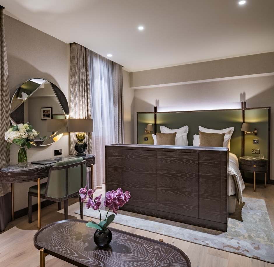 king size bed, a table, a desk by the wall