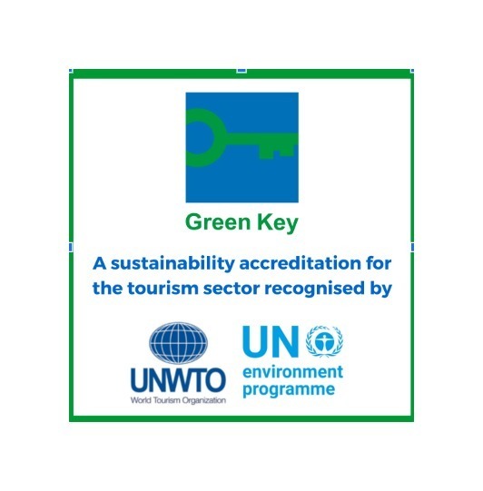 Green Key sustainability accreditation logo with text noting recognition by UNWTO and UN Environment Programme.
