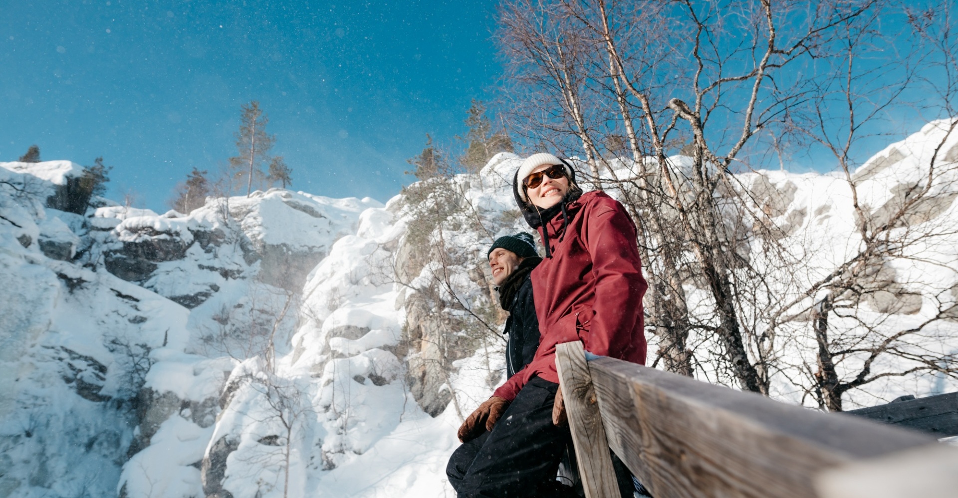 Two people sitting in the wilderness and admiring the view.